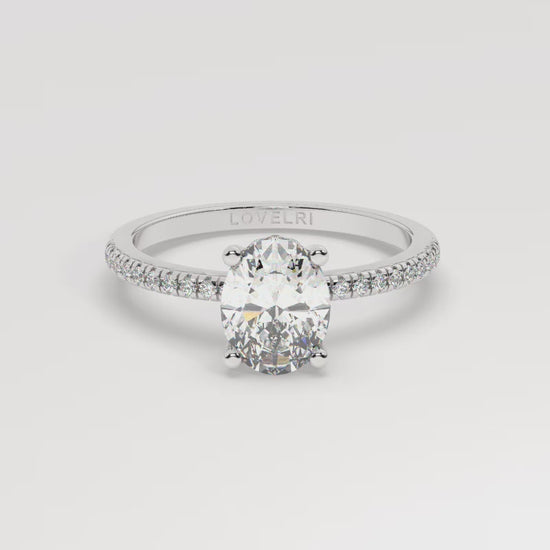 White gold oval diamond set with a hidden halo on a pave setting - 360 view