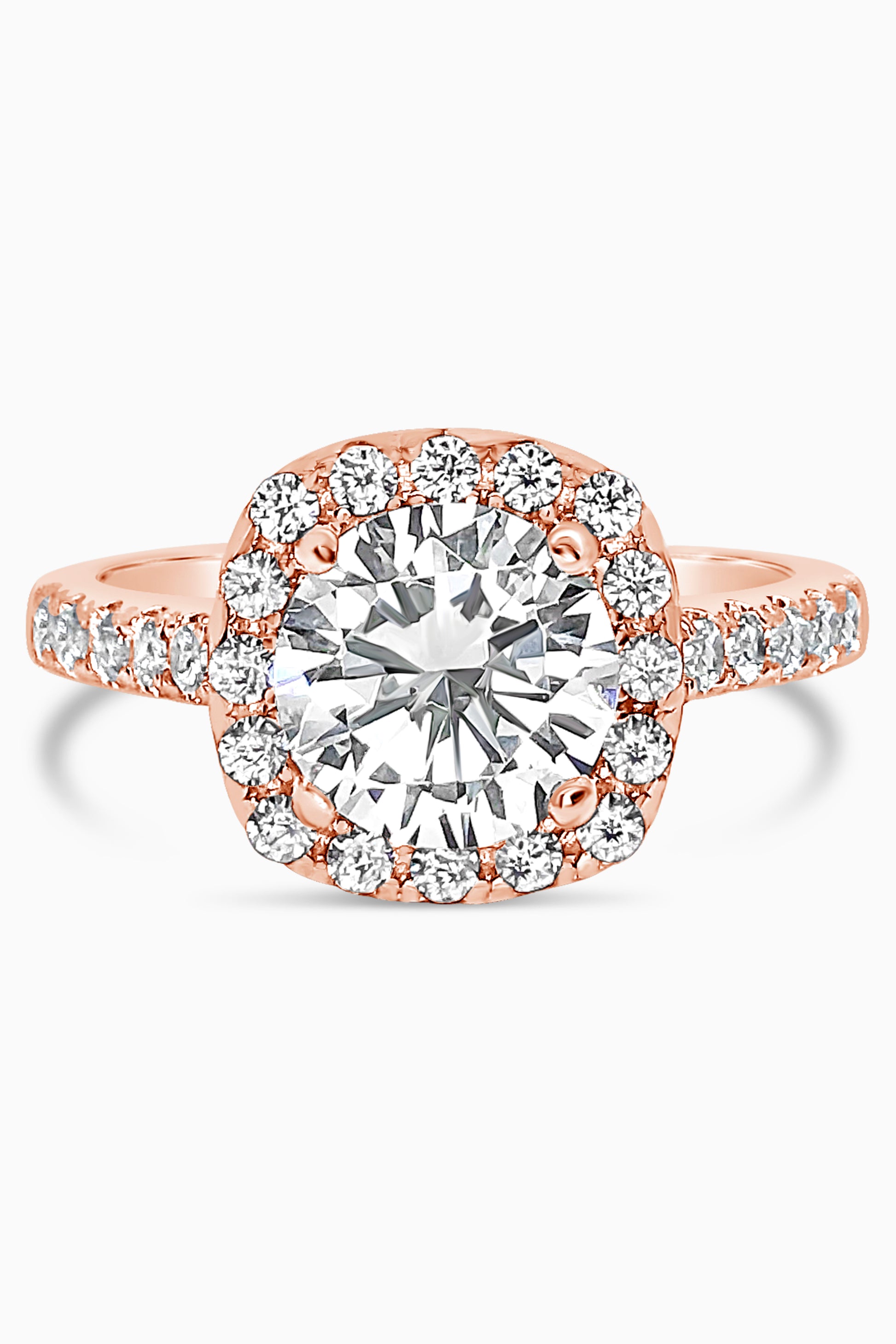 Rose Gold round cut stone surrounded by a Square Halo and Pavé band