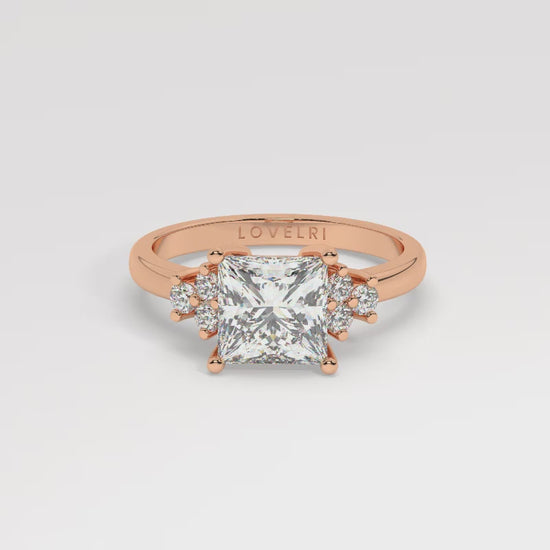 Rose Gold Princess Cut Engagement Ring Accompanied by Round Stones - 360 View