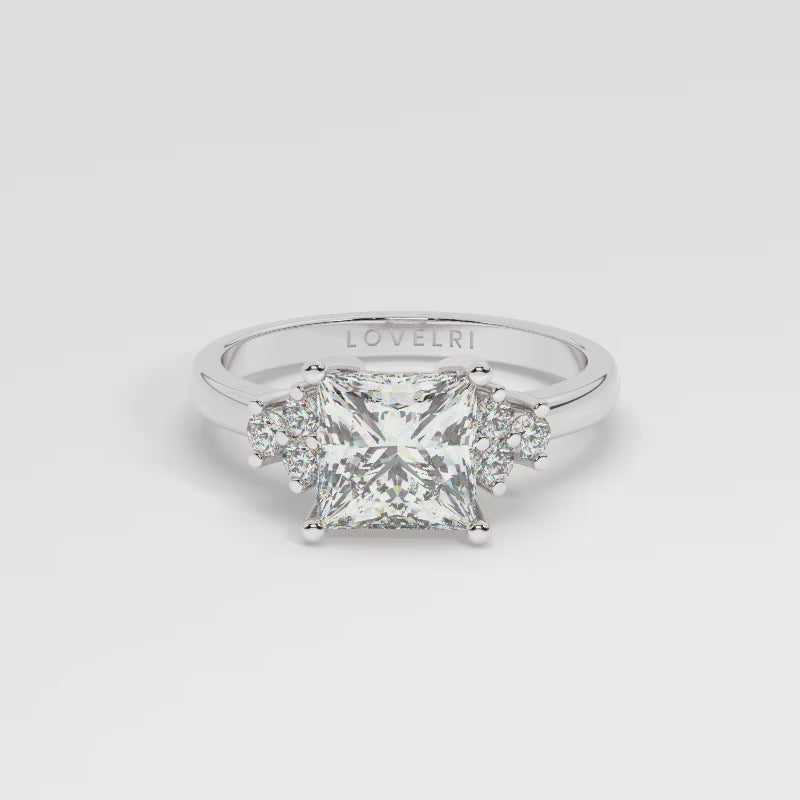 White Gold Princess Cut Engagement Ring Accompanied by Round Stones - 360 View